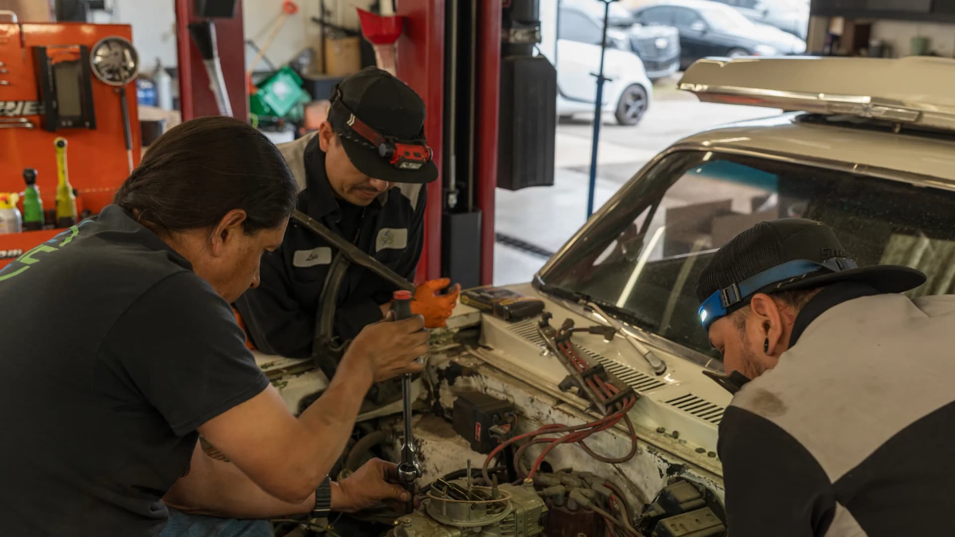 Technicians inspecting engine components during teardown at RKC Automotive